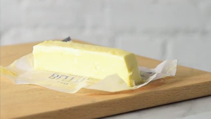 butter on a wooden cutting board