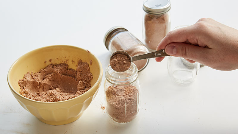 Spoon cake mix into jars