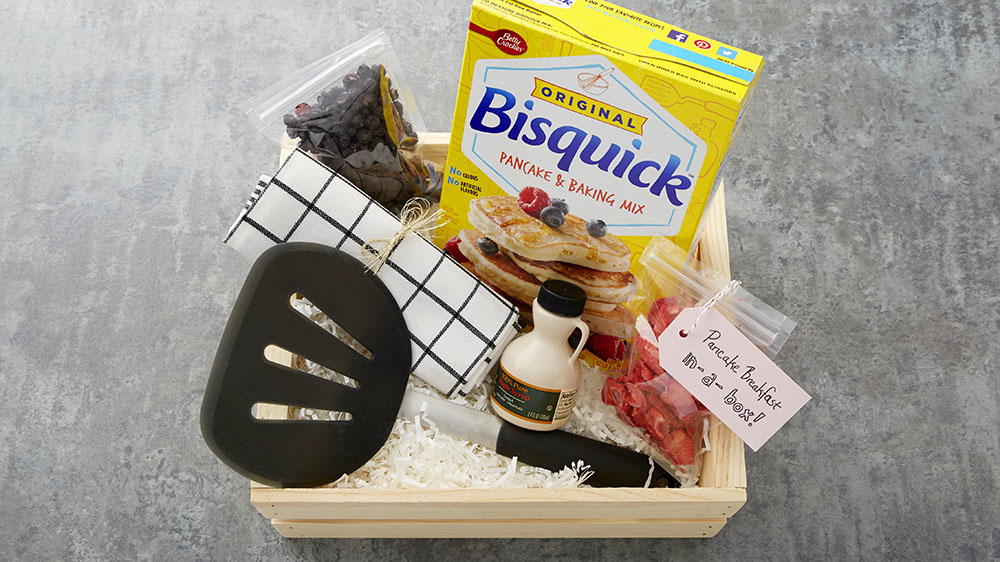 pancake gift basket with bisquick, pancake spatula, syrup, dried fruit and kitchen towel