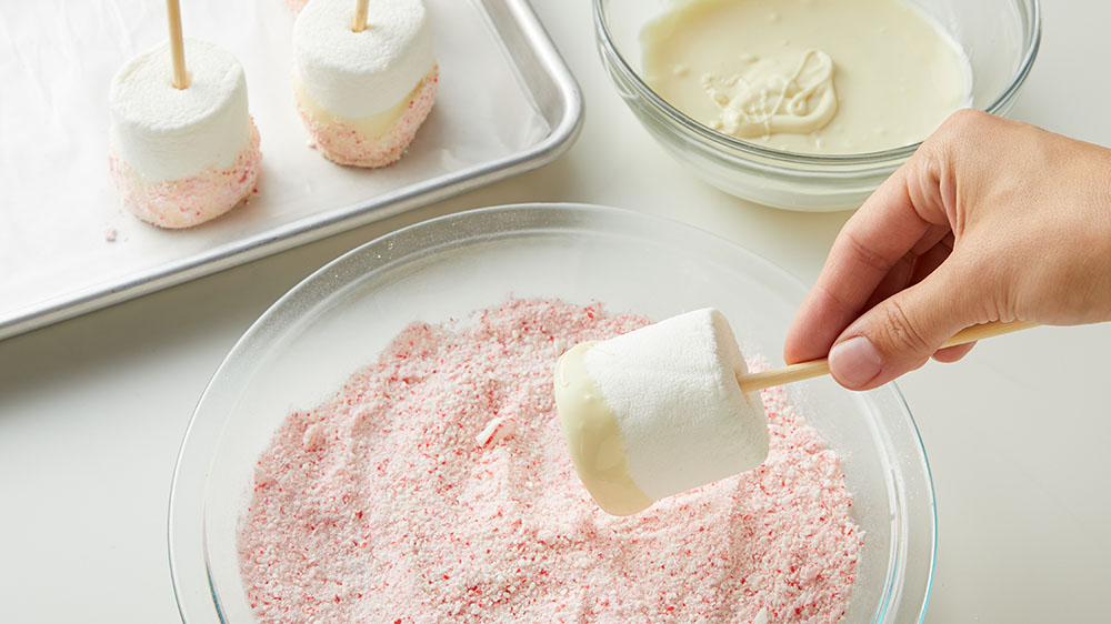 dipping marshmallow in candy cane dust