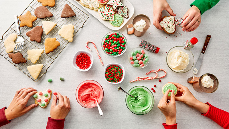 Sugar cookies, frosting, red and green candies, candy canes