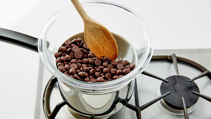 Chocolate chips in a double boiler on a stove