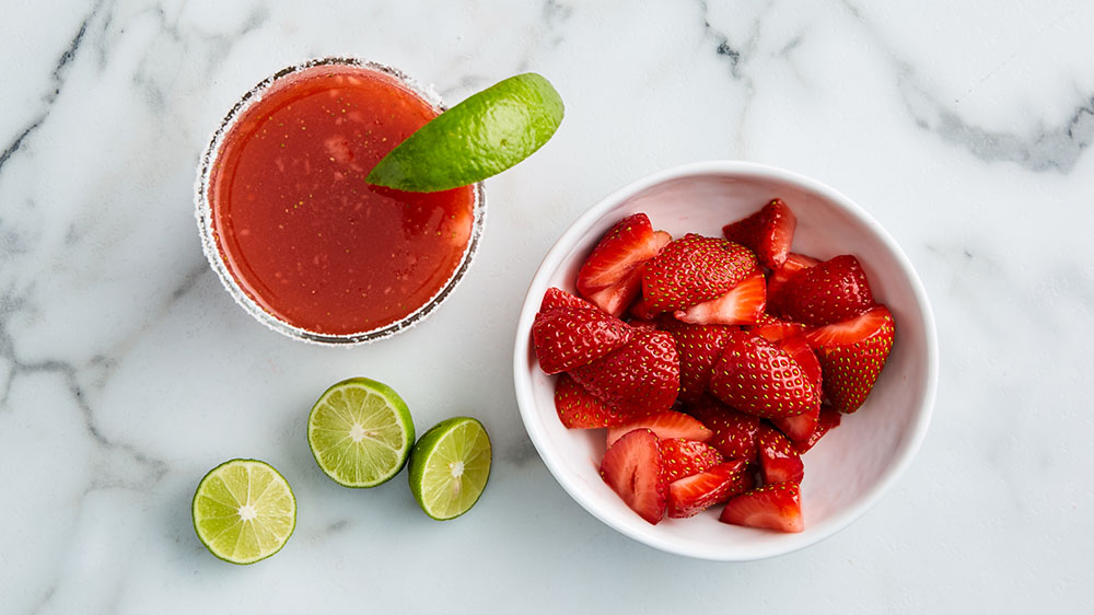 strawberry margarita, limes, bowl of strawberries
