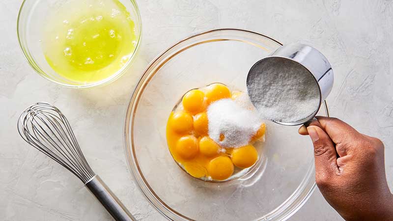 Combine yolks and sugar in a large mixing bowl 