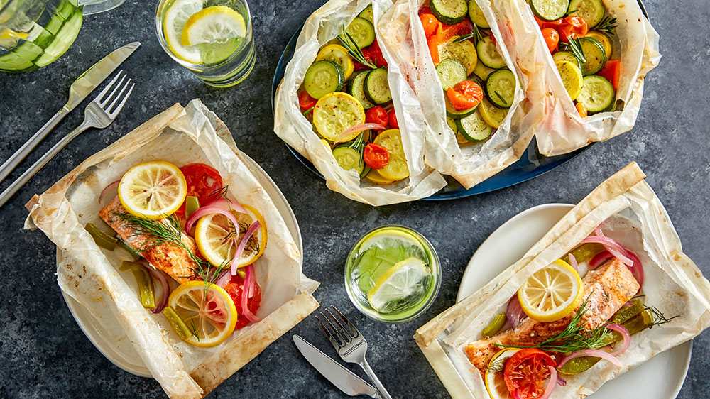 fish and vegetables being cooked in parchment paper