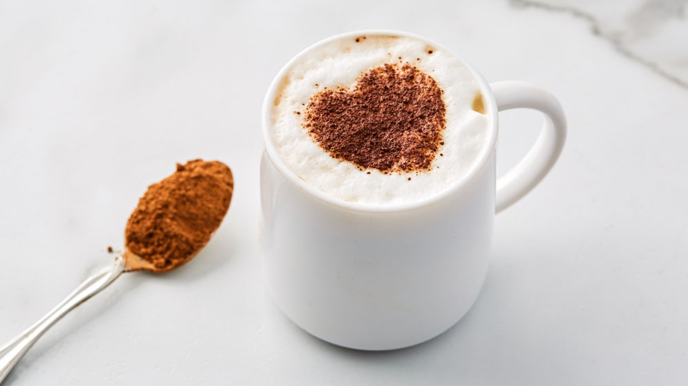 latte cup with heart made of cocoa