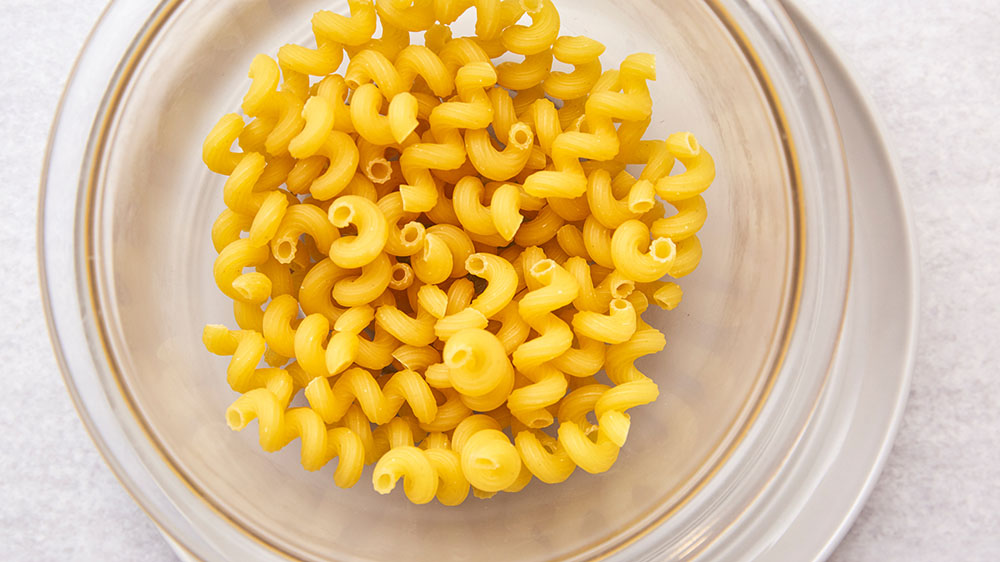 Add ½ to 1 cup of dry pasta to the microwave-safe bowl