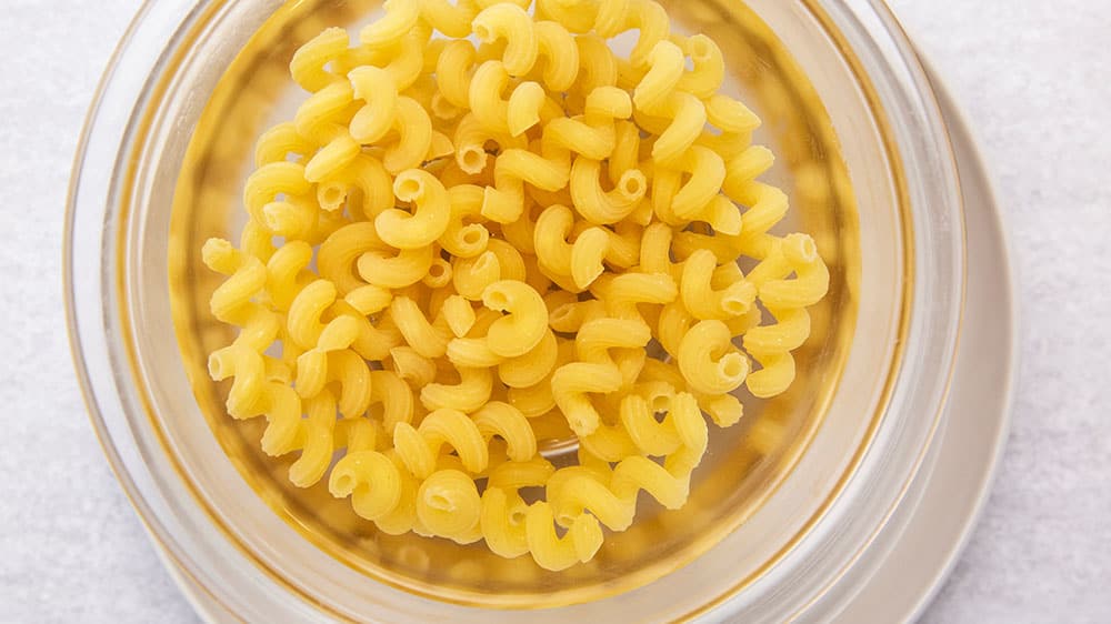 Fill the bowl with water to the point where water tops the pasta by a couple of inches. 