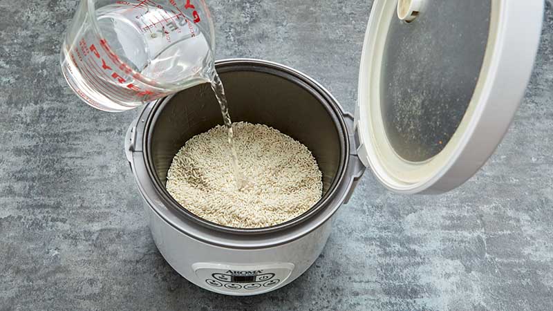 Measure two cups of rice and two and a half cups of water into the rice cooker
