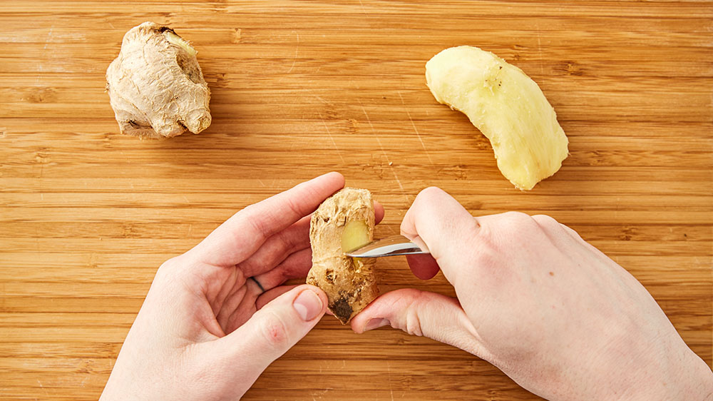 peeling ginger with a spoon