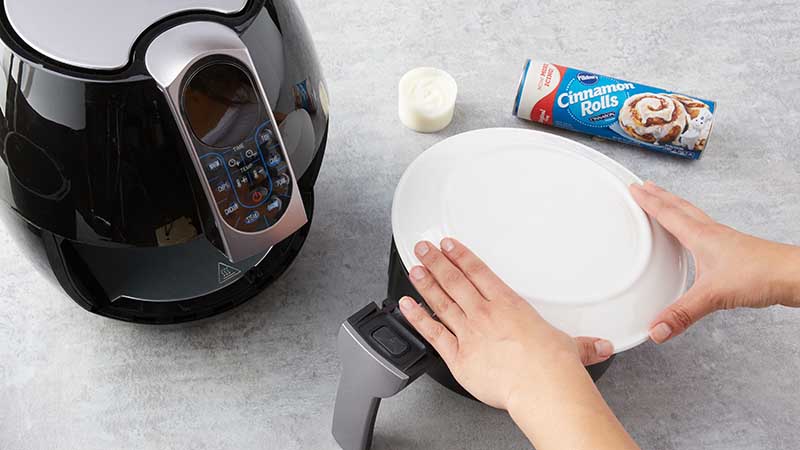 Place large plate over air fryer basket and invert.