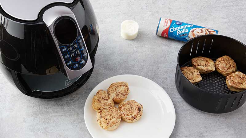 Carefully transfer cinnamon rolls back to air fryer