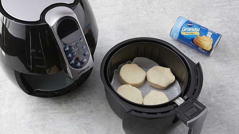 Place 4 biscuits on parchment in air fryer basket. 